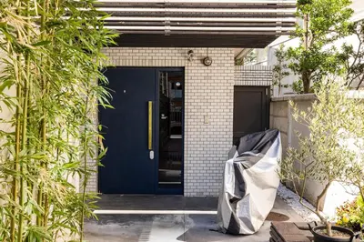 a blue front door of a house with plants at Aoyama Roppongi Fully renovated Japanese house in Tokyo