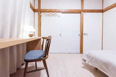 a bedroom with a desk and a chair next to a bed at Shōwamachi 3bedrooms KI0325 in Tokyo