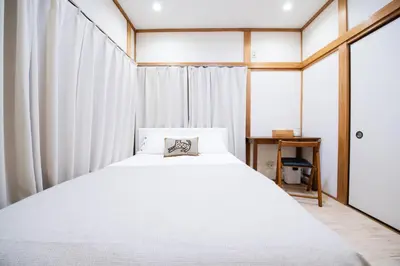 a bedroom with a large white bed and a window at Shōwamachi 3bedrooms KI0325 in Tokyo