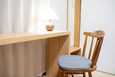 a wooden desk with a chair with a lamp on it at Shōwamachi 3bedrooms KI0325 in Tokyo