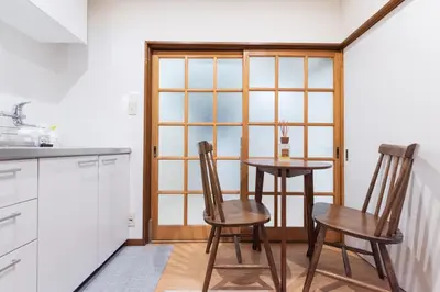 a kitchen with a table and two chairs and a window at Shōwamachi 3bedrooms KI0325 in Tokyo