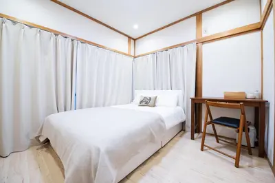 a bedroom with a bed and a desk and a window at Shōwamachi 3bedrooms KI0325 in Tokyo