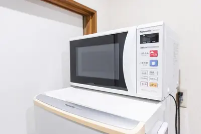 a microwave oven sitting on top of a shelf at Shōwamachi 3bedrooms KI0325 in Tokyo