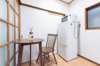 a kitchen with a table and a refrigerator at Shōwamachi 3bedrooms KI0325 in Tokyo