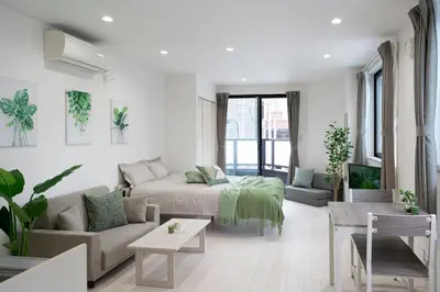 a white living room with a couch and a bed at CASA201 1-minute walk from the station, Asakusa, Akihabara, Ginza, Tsukiji, Toyosu, Shinjuku, Shibuya, Narita, Haneda, good access in Tokyo