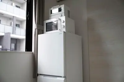 a white refrigerator with a microwave on top of it at CASA201 1-minute walk from the station, Asakusa, Akihabara, Ginza, Tsukiji, Toyosu, Shinjuku, Shibuya, Narita, Haneda, good access in Tokyo