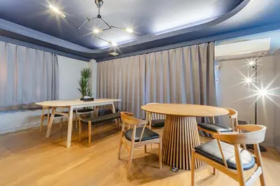 a dining room with two tables and chairs at LINKAGE STAY Chitose Funabashi in Tokyo
