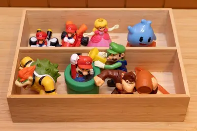 a wooden box filled with different toy toys at LINKAGE STAY Chitose Funabashi in Tokyo