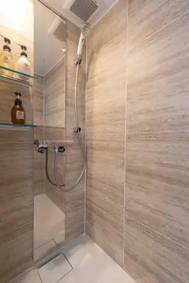 a bathroom with a shower with a glass door at LINKAGE STAY Chitose Funabashi in Tokyo