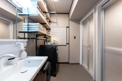 a bathroom with a sink and a mirror at Kstyle Apartments KURI in Tokyo