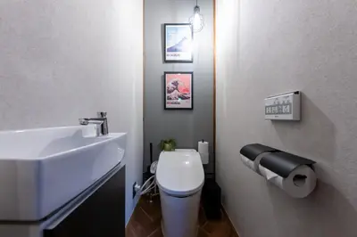 a bathroom with a white toilet and a sink at Kstyle Apartments KURI in Tokyo