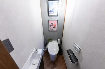 a small bathroom with a toilet and a sink at Kstyle Apartments KURI in Tokyo