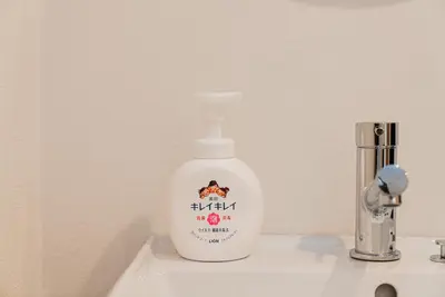 a bottle of mouthwash sitting on a bathroom sink at Promotion Itabashi , 1 room, Max 4P \u8d85\u9ad8\u6027\u4ef7\u6bd4 \u677f\u6865\u5168\u65b0\u88c5\u4fee \u8bbe\u5907\u9f50\u5168 \u65e0\u7ebf\u7f51\u7edc \u6700\u59274\u4eba in Tokyo