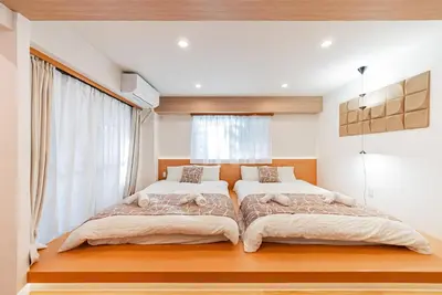 a bedroom with two beds and a window at Promotion Itabashi , 1 room, Max 4P \u8d85\u9ad8\u6027\u4ef7\u6bd4 \u677f\u6865\u5168\u65b0\u88c5\u4fee \u8bbe\u5907\u9f50\u5168 \u65e0\u7ebf\u7f51\u7edc \u6700\u59274\u4eba in Tokyo