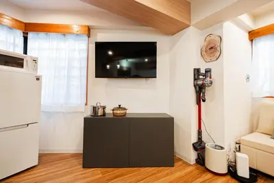 a kitchen with a black cabinet and a tv on the wall at Promotion Itabashi , 1 room, Max 4P \u8d85\u9ad8\u6027\u4ef7\u6bd4 \u677f\u6865\u5168\u65b0\u88c5\u4fee \u8bbe\u5907\u9f50\u5168 \u65e0\u7ebf\u7f51\u7edc \u6700\u59274\u4eba in Tokyo