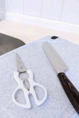 a pair of scissors on a counter next to a knife at Bright Skytree View Apartment,6 Min Walk to Kinshicho Station in Tokyo