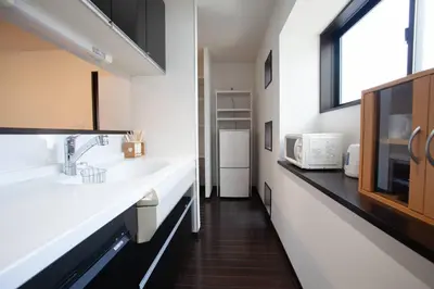 a kitchen with two sinks and a microwave at Ks\u897f\u65e9\u7a32\u7530 2F in Tokyo