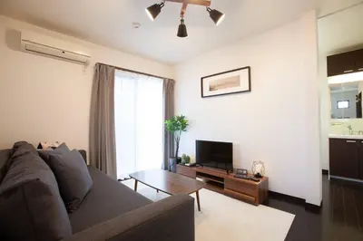 a living room with a couch and a table at Ks\u897f\u65e9\u7a32\u7530 2F in Tokyo