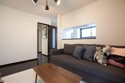 a living room with a couch and a table at Ks\u897f\u65e9\u7a32\u7530 2F in Tokyo