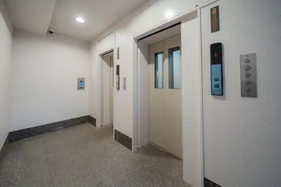 a hallway with white walls and doors in a building at unito residence EBISU STATION North in Tokyo