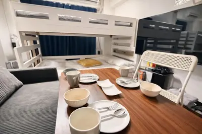 a table with plates and utensils on top of a bed at GrAce Room IKEBUKURO in Tokyo