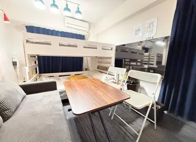 a room with a bed and a table and chairs at GrAce Room IKEBUKURO in Tokyo