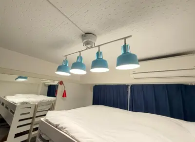 a hospital room with two beds and three lights at GrAce Room IKEBUKURO in Tokyo