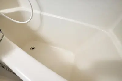 a white bath tub with a white hose at GrAce Room IKEBUKURO in Tokyo