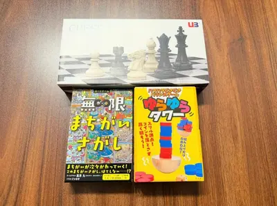 two magazines sitting on a table with a chess game at GrAce Room IKEBUKURO in Tokyo