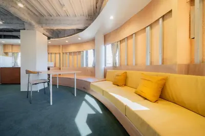 an office with a yellow couch and a table at \u30ec\u30b8\u30fc\u30f3\u6075\u6bd4\u5bff in Tokyo