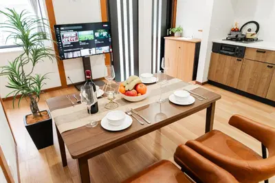 a dining room with a table with a bowl of fruit at NISHIKI Ryokan\u9326\u65c5\u9928 in Tokyo