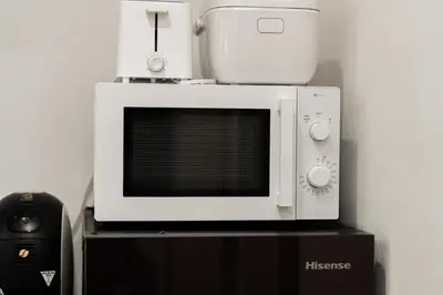 a microwave oven sitting on top of a table at NISHIKI Ryokan\u9326\u65c5\u9928 in Tokyo