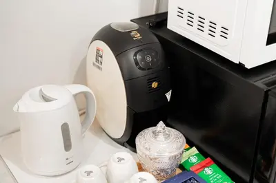 a coffee maker sitting on top of a microwave at NISHIKI Ryokan\u9326\u65c5\u9928 in Tokyo