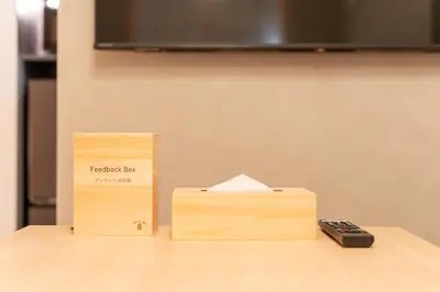 a remote control sitting next to a box on a table at T-home\u666f T-home KEI in Tokyo