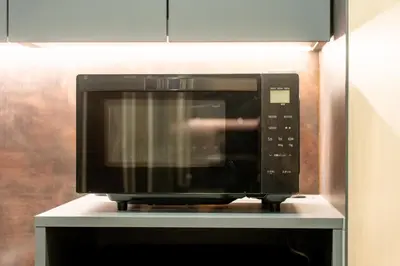 a microwave oven sitting on top of a shelf at T-home\u666f T-home KEI in Tokyo