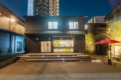 a building with a red umbrella in front of it at T-home\u666f T-home KEI in Tokyo