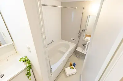 a white bathroom with a tub and a sink at Oshiage 3-chome Entire House Near Skytree in Tokyo