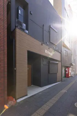 a building with a garage with a sign on it at \u30a2\u30f3\u30c9\u30b9\u30c6\u30a4\u5343\u4f4f\u4ef2\u753aa in Tokyo