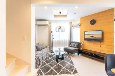 a living room with a couch and a tv at Spacious Skytree Stay, 8 Guests, Asakusa 11 mins, Modern Renovation, 8-min Walk to Station in Tokyo