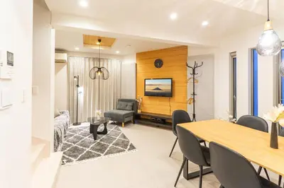 a dining room and living room with a table and chairs at Spacious Skytree Stay, 8 Guests, Asakusa 11 mins, Modern Renovation, 8-min Walk to Station in Tokyo