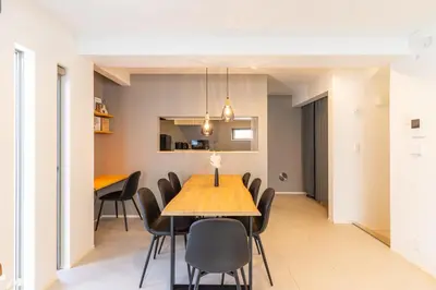 a dining room with a wooden table and chairs at Spacious Skytree Stay, 8 Guests, Asakusa 11 mins, Modern Renovation, 8-min Walk to Station in Tokyo
