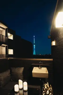 a bathroom with a sink and a tower in the background at Spacious Skytree Stay, 8 Guests, Asakusa 11 mins, Modern Renovation, 8-min Walk to Station in Tokyo