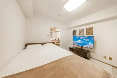 a white bedroom with a large bed and a desk at 8 min to Ikebukuro, 6 min walk from Yomachi Station, Max 2 people, Straight to Tokyo, Shinjuku, Shibuya, Ueno 302 in Tokyo