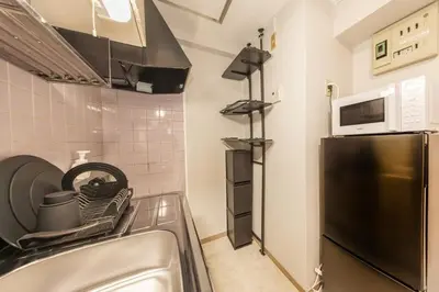 a kitchen with a sink and a refrigerator at 8 min to Ikebukuro, 6 min walk from Yomachi Station, Max 2 people, Straight to Tokyo, Shinjuku, Shibuya, Ueno 302 in Tokyo