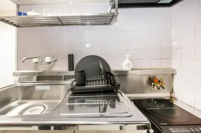a kitchen sink with a dish drying rack on it at 8 min to Ikebukuro, 6 min walk from Yomachi Station, Max 2 people, Straight to Tokyo, Shinjuku, Shibuya, Ueno 302 in Tokyo