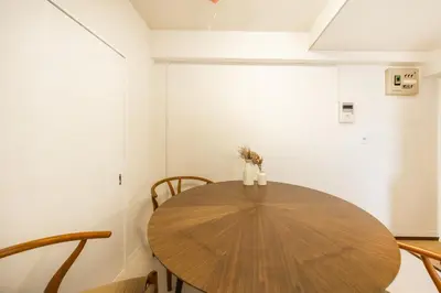 a dining room with a wooden table and chairs at 8 mins walk to Ikebukuro, 6 mins to Kanamecho Station, Max 2 people, Direct access to Tokyo, Shinjuku, Shibuya, Ueno 503 in Tokyo