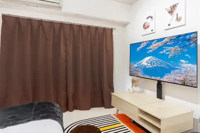 a bedroom with a large screen tv in a room at 8 mins walk to Ikebukuro, 6 mins to Kanamecho Station, Max 2 people, Direct access to Tokyo, Shinjuku, Shibuya, Ueno 503 in Tokyo