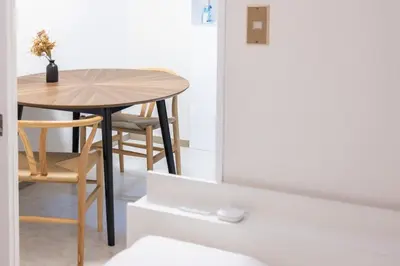 a dining room table with a small table and chairs at 8 minutes on foot from Ikebukuro, 6 minutes on foot from Kanamecho Station, Maximum 2 people, Direct to Tokyo, Shinjuku, Shibuya, Ueno 102 in Tokyo