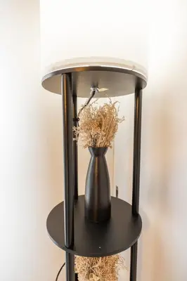a black lamp with a vase with flowers on a table at 8 minutes on foot from Ikebukuro, 6 minutes on foot from Kanamecho Station, Maximum 2 people, Direct to Tokyo, Shinjuku, Shibuya, Ueno 102 in Tokyo