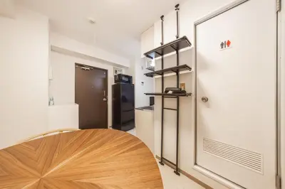 a room with a door and a table and a kitchen at 8 minutes on foot from Ikebukuro, 6 minutes on foot from Kanamecho Station, Maximum 2 people, Direct to Tokyo, Shinjuku, Shibuya, Ueno 102 in Tokyo